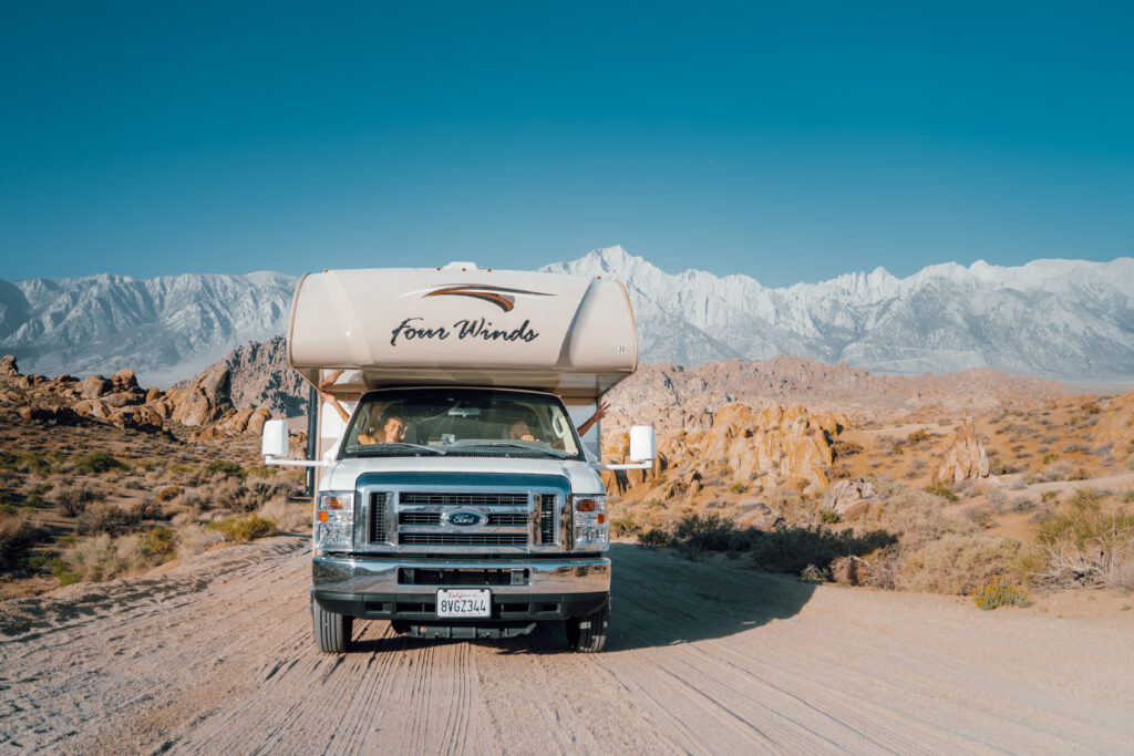 an RV in front of snow covered mountains