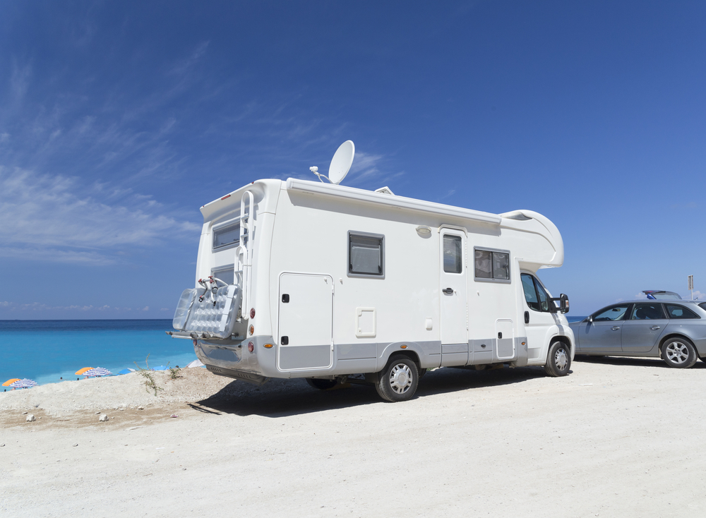 An RV by the seaside with an antenna up