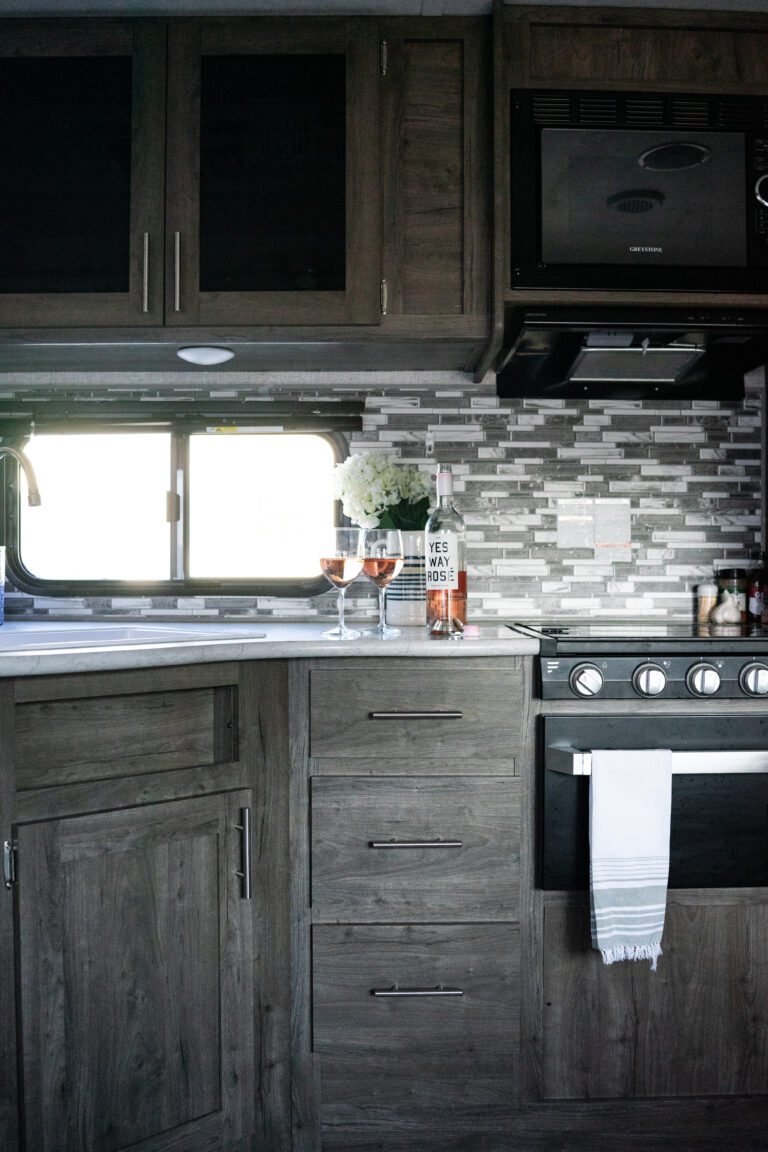 an RV kitchen with wineglasses