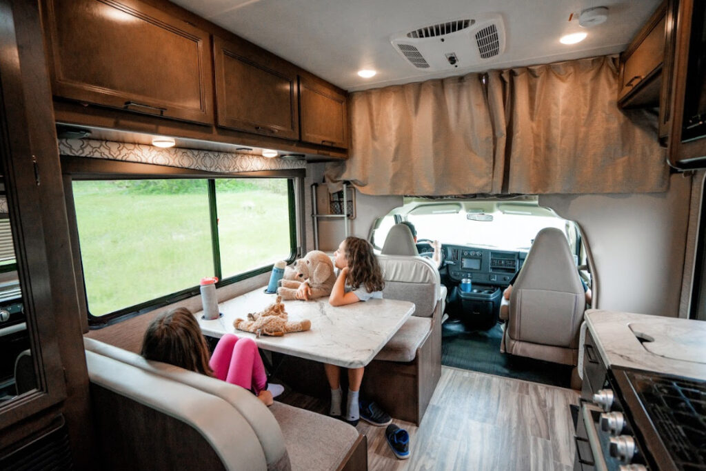 a family at their dinette inside their RV