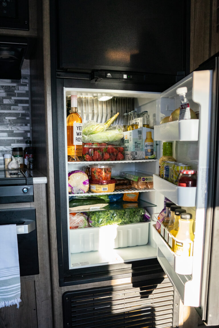 An open and fully stocked RV fridge