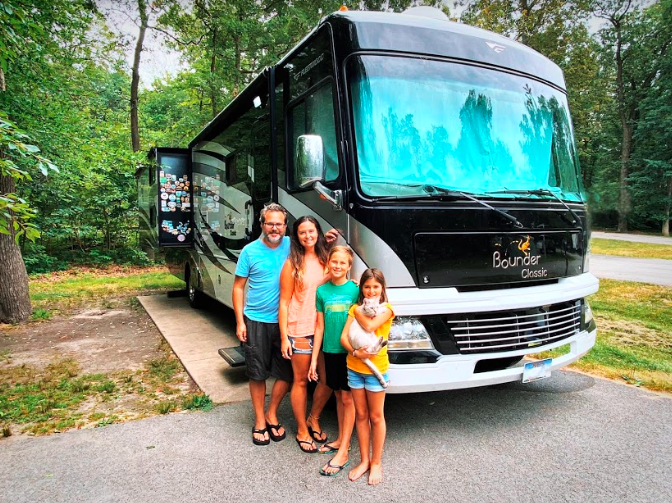 a family in front of an RV motorhome