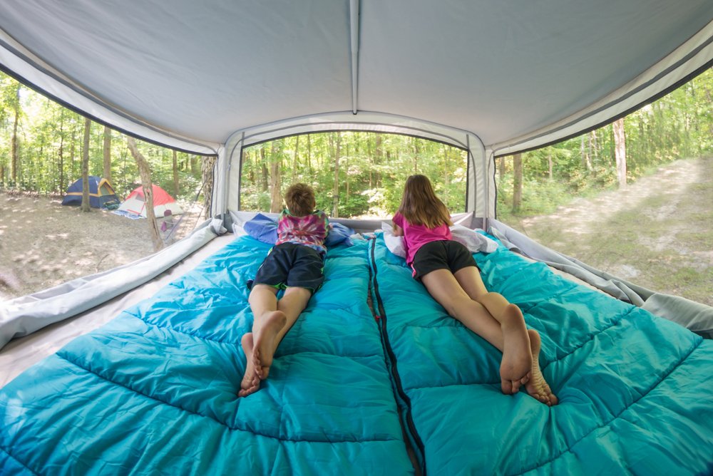 two kids relaxing in a pop up camper