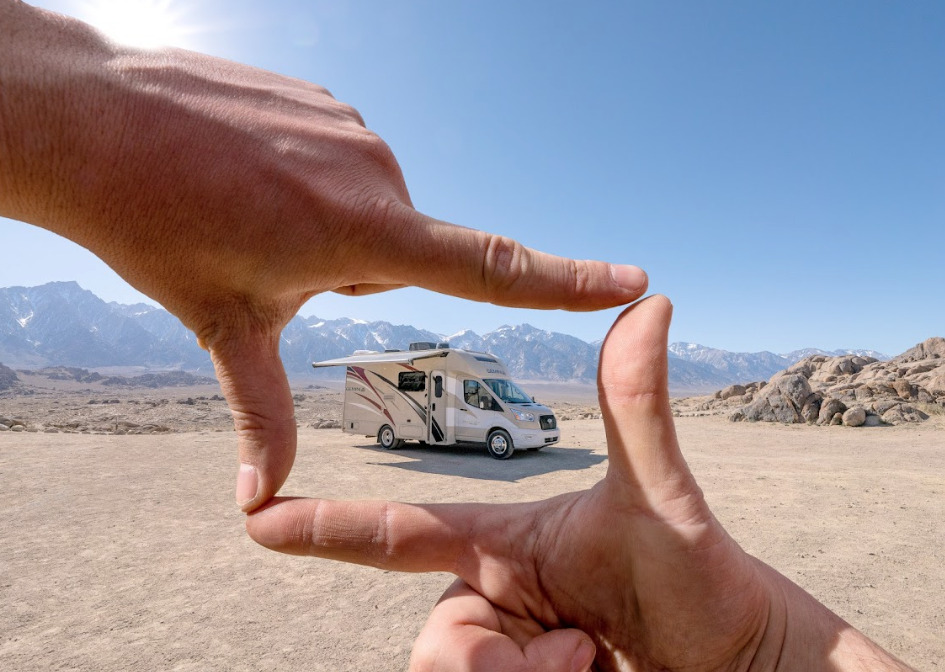 an RV pictured between someone's fingers