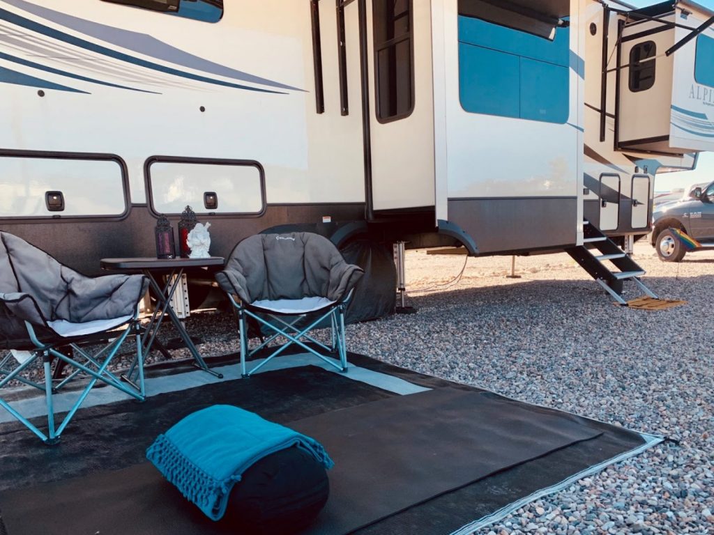 outdoor seating in front of a class a rv