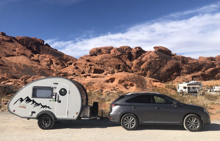 nuCamp Tab s teardrop camper with red canyons in the background