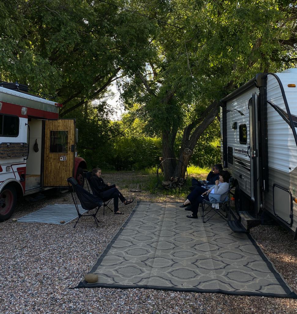 family outside RVs camping